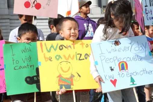 Children holding posters outside San Francisco City Hall.